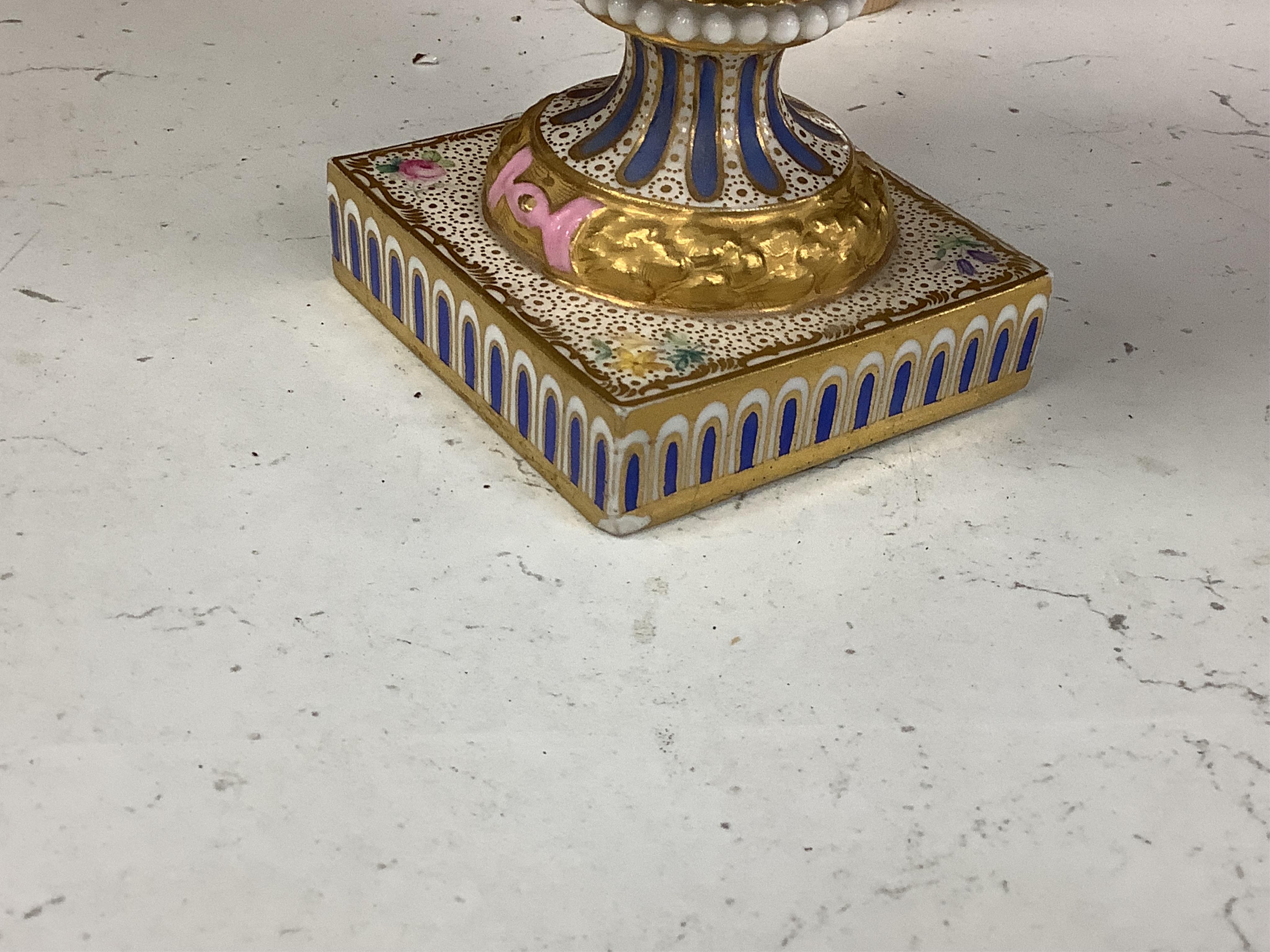 A pair of 19th century Sevres style porcelain vases hand painted with flowers, 22cm high